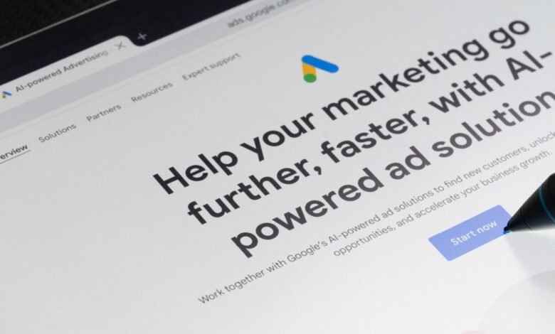 Google Ads AI-powered marketing webpage shown on a tablet screen; a stylus hovers over the 'Start now' button.