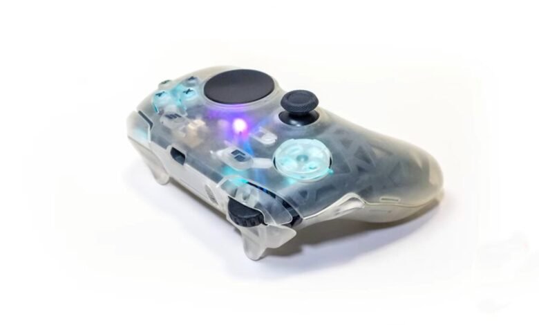Transparent gaming controller with illuminated buttons and internal components visible.