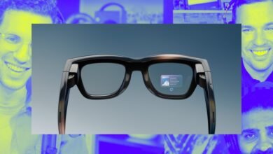 Close-up of sleek black smart glasses displaying an augmented reality overlay of Santorini.