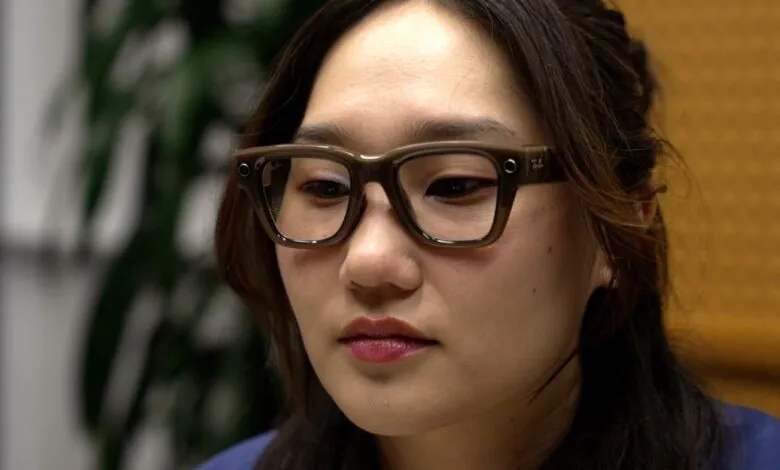 Close-up of a woman wearing Ray-Ban smart glasses, looking thoughtfully.