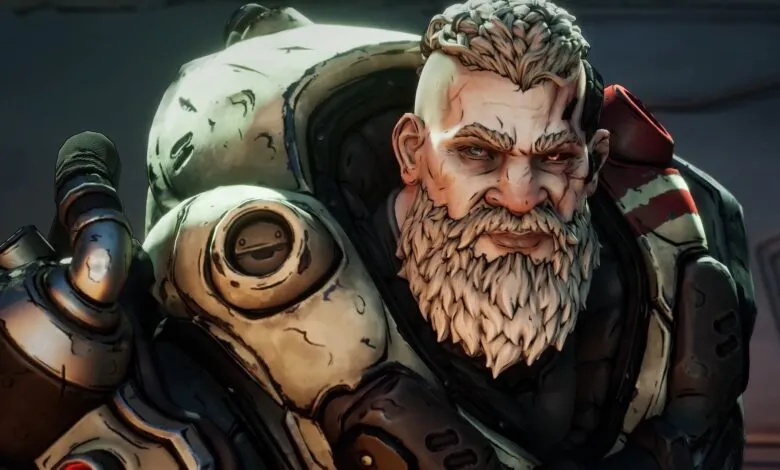 Close-up of a grizzled, long-bearded man in futuristic armor, intense gaze.