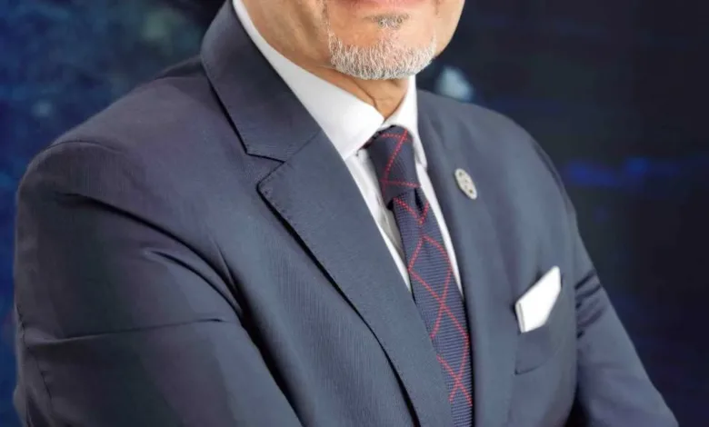 Portrait of Walid Gomaa, CEO of Omnix International, wearing a suit and tie.