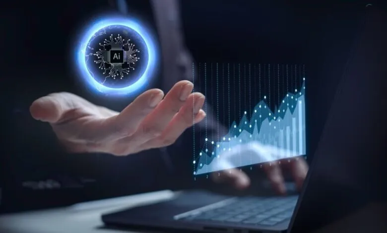 Person's hand displays a glowing AI microchip graphic above a rising data graph on a laptop.