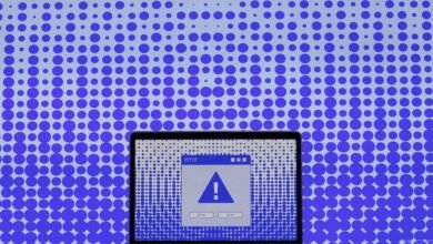 Laptop displaying an error message against a background of purple circles.