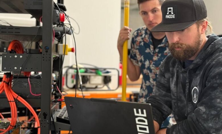 Two men working with technology and equipment in a lab setting.