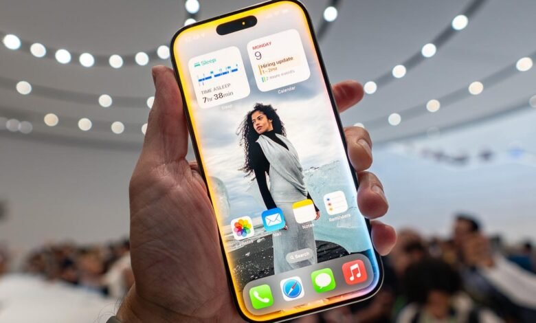Hand holding iPhone 16 showcasing its new features, including a vibrant display and updated widgets.