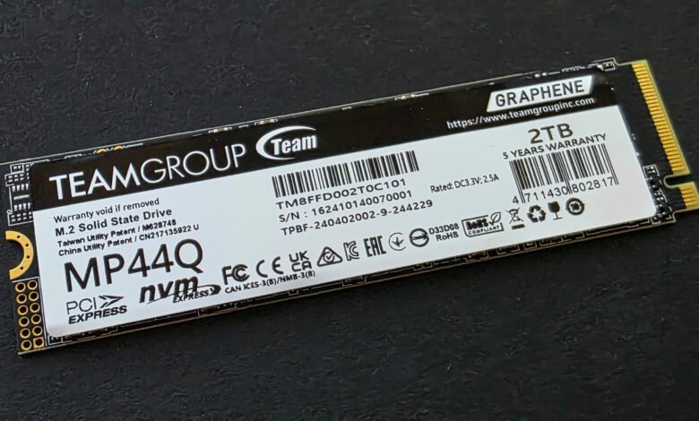 Close-up of a TeamGroup MP44Q 2TB M.2 NVMe PCIe SSD, showcasing its specifications and warranty information.