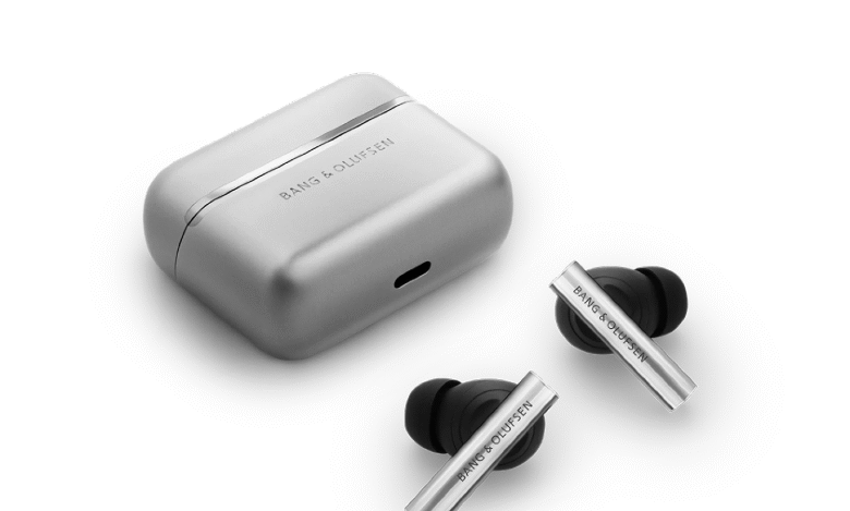 Bang & Olufsen earbuds and charging case in silver. Sleek design, premium audio.