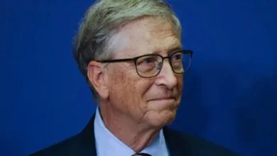 Close-up portrait of Bill Gates wearing glasses and a suit, looking to the right.