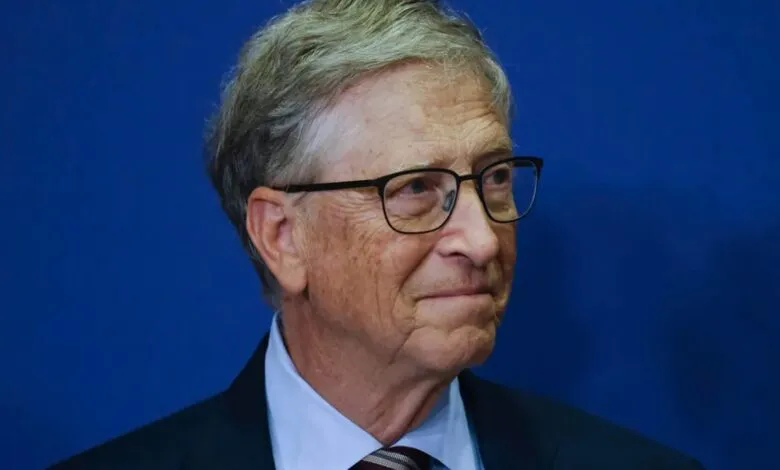 Close-up portrait of Bill Gates wearing glasses and a suit, looking to the right.