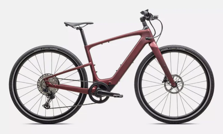 Sleek, maroon electric bike with carbon fiber frame, showcasing its modern design and integrated technology.