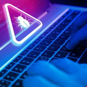Cybersecurity warning: Bug icon on laptop screen with hands typing.