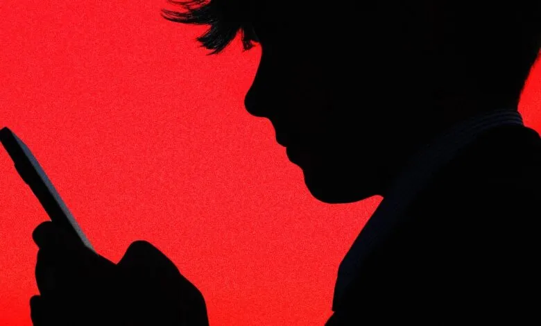 Silhouette of a person's head and hand holding a smartphone against a vibrant red background.