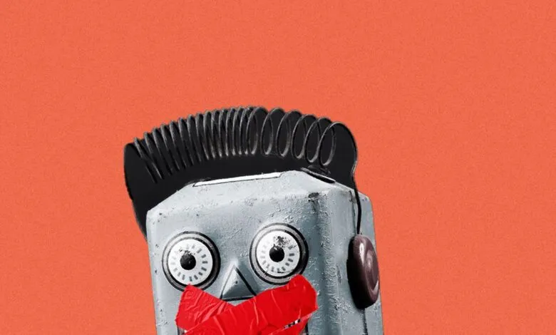 Close-up of a vintage robot head with red tape over its mouth and a coiled spring for hair.