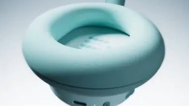 Close-up of a light teal headphone earcup, showcasing its soft texture and subtle speaker grill.