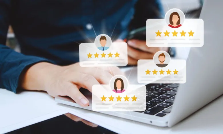 Person using laptop, five-star reviews appear above keyboard.