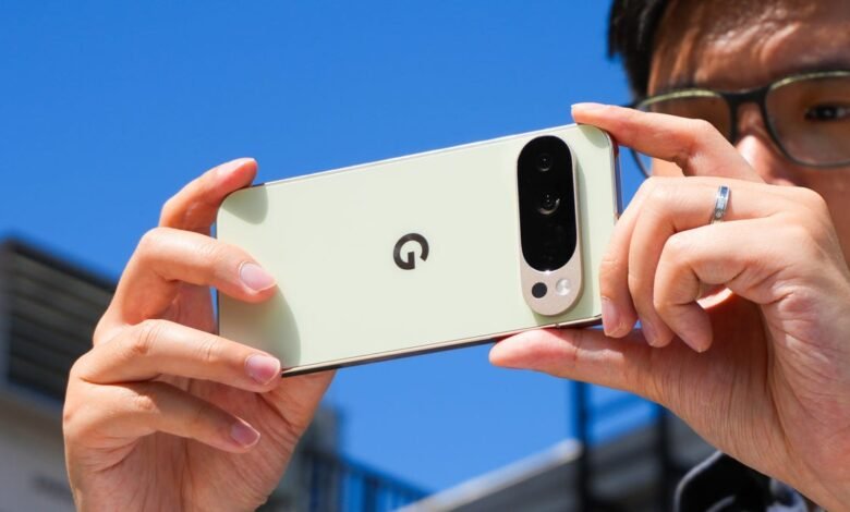 Person holding a light green Google Pixel phone horizontally to take a photo outdoors.