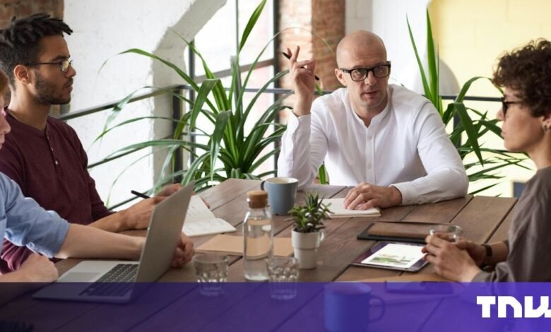 Business team meeting around a table, collaborating and discussing ideas.