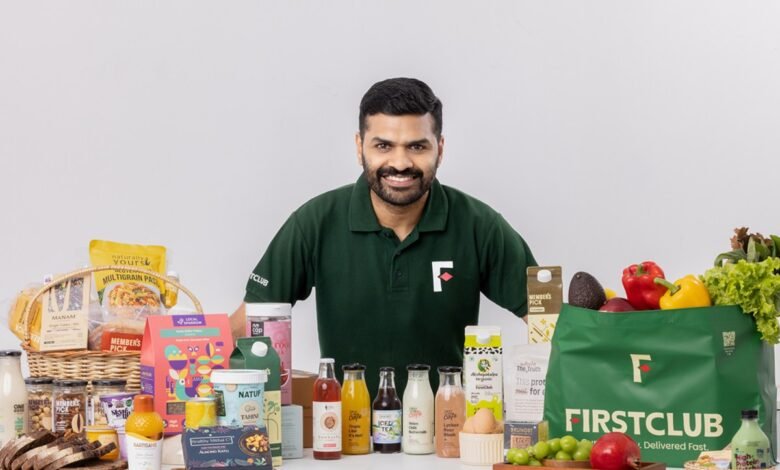 Ayyappan R, FirstClub founder, smiles proudly before a display of the company's diverse, healthy food and drink products.