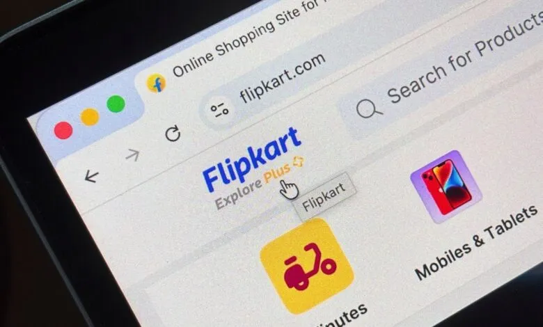 Close-up of a computer screen showing the Flipkart website with a cursor hovering over the 'Flipkart' button.