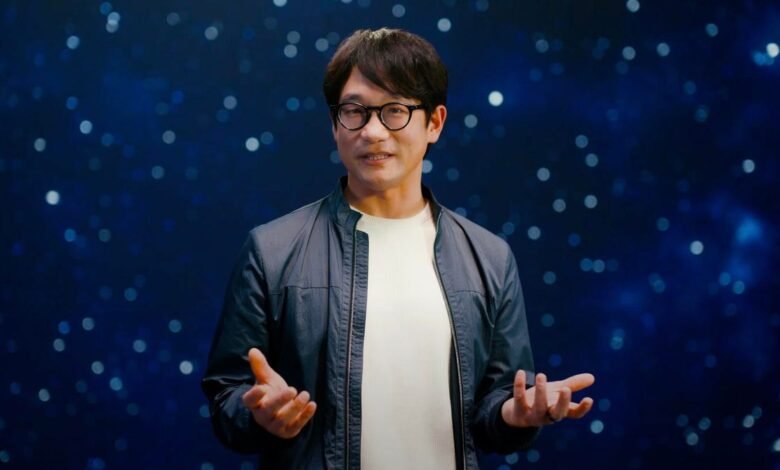 Hideo Kojima, video game creator, speaks against a dark blue, star-filled background.