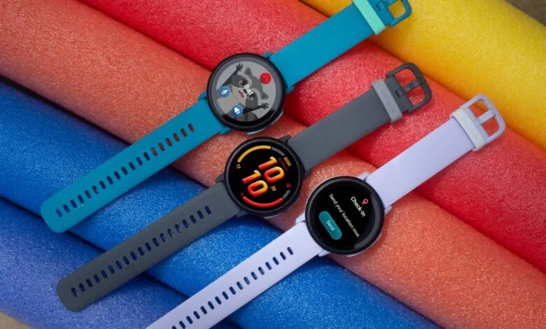 Three Garmin Bounce 2 smartwatches in teal, gray, and lavender, displayed on colorful foam rollers.