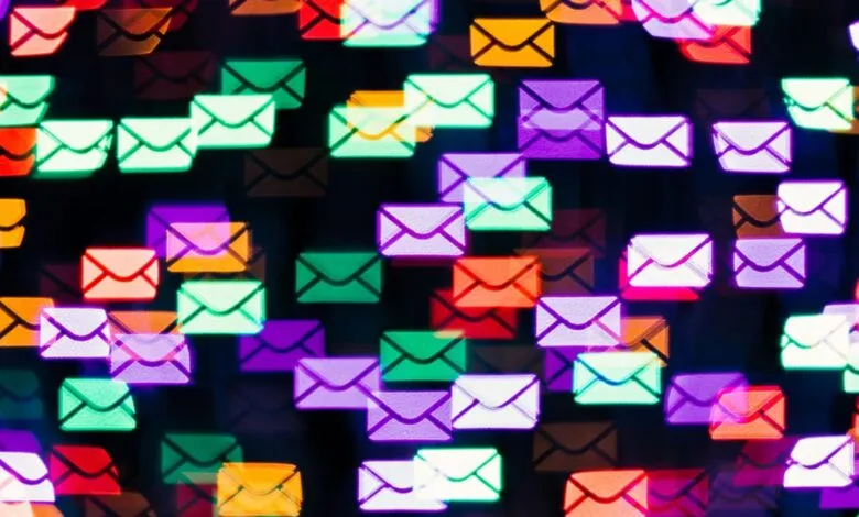 Abstract background of colorful, blurred email icons in bokeh effect.