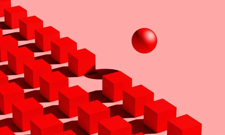 A single red sphere floats above a diagonal line of red cubes against a pink background.