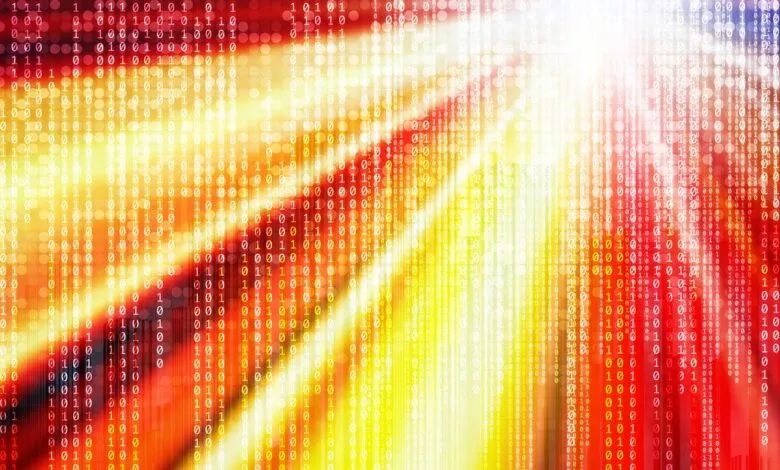 Abstract digital background with binary code in shades of red, orange, and yellow.