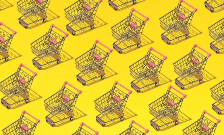 Pattern of miniature shopping carts with pink handles on a bright yellow background.