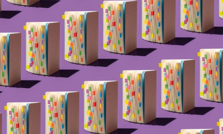 Repeating pattern of open notebooks with colorful sticky notes on a purple background.
