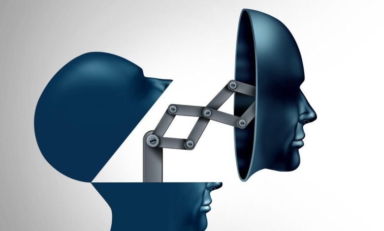 Abstract image of two dark blue human heads connected by a mechanical linkage.