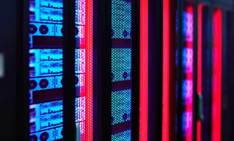 Close-up of vibrant blue and red illuminated server racks in a data center.
