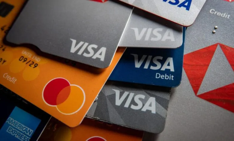 Close-up of various Visa credit and debit cards, showcasing different designs and colors.
