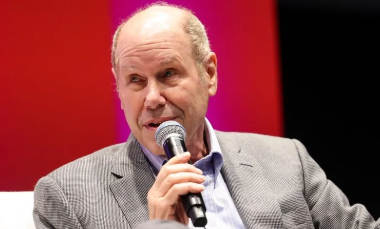 Close-up of Al Gore speaking at an event, holding a microphone.