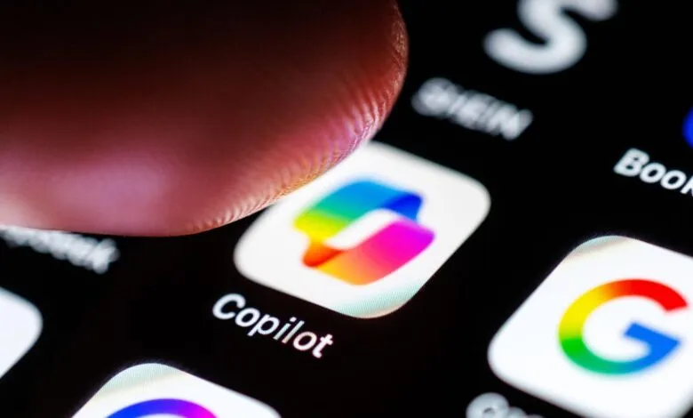 Close-up of a finger touching the Copilot app icon on a smartphone screen.