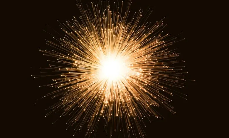 Abstract burst of glowing orange fiber optic strands against a dark background.