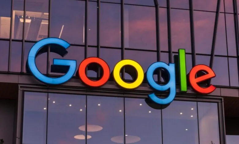 Google logo on a building at sunset. The letters are large and brightly colored.