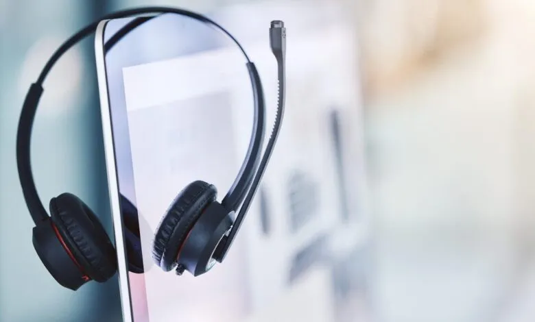 Black headset rests on a tablet, suggesting communication or customer service.