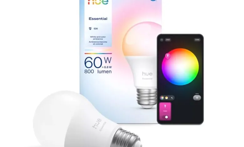 Philips Hue Essential smart bulb with color-changing capabilities, shown in its box with a smartphone app interface.