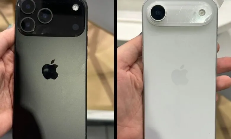 Comparison of iPhone models: a dark gray phone and a white phone in protective cases, showcasing their rear camera systems.