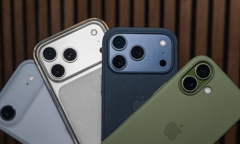 Close-up of iPhone models in various cases: silver, dark blue, and olive green, showcasing their camera systems.