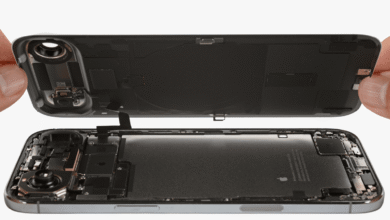 Hands carefully separating the back panel from an iPhone's internal components.