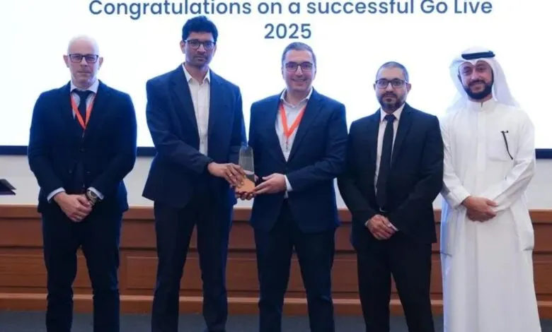 Team celebrating successful 2025 Go-Live, holding award.