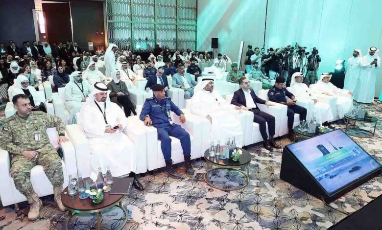 Men in traditional attire and military uniforms seated in a conference hall.