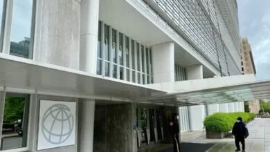 Entrance to the International Monetary Fund building with security guards present.