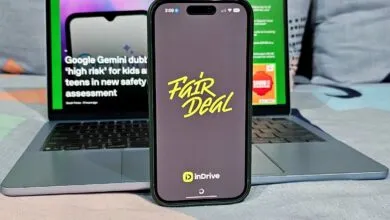 Smartphone displaying the inDrive Fair Deal app on a laptop with a TechCrunch article visible.