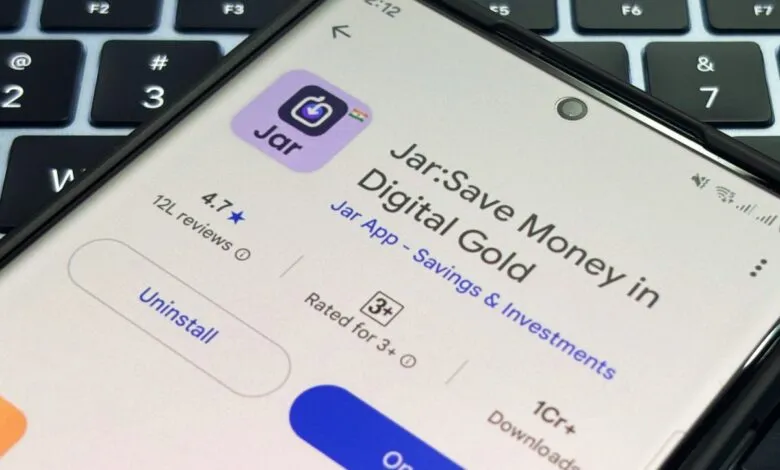Smartphone displaying the Jar app, a digital gold savings and investment platform with a 4.7-star rating and over 1 crore downloads.
