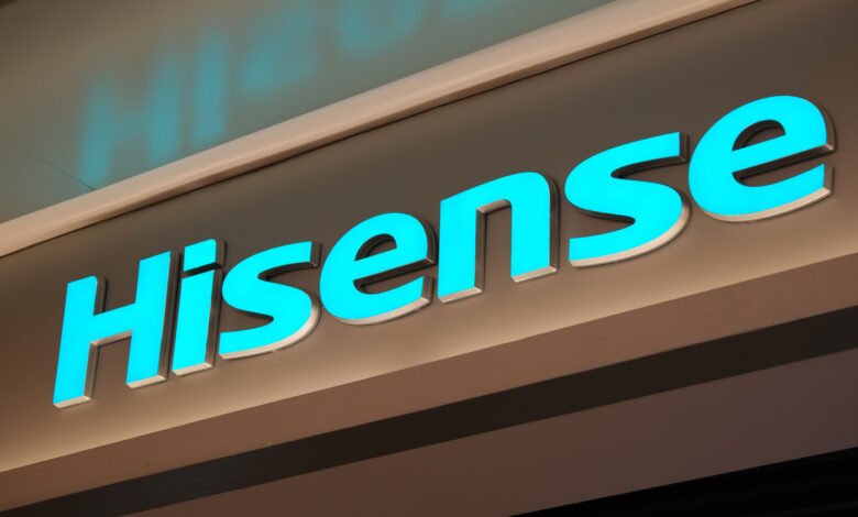 Close-up of illuminated Hisense logo with bright blue lettering.