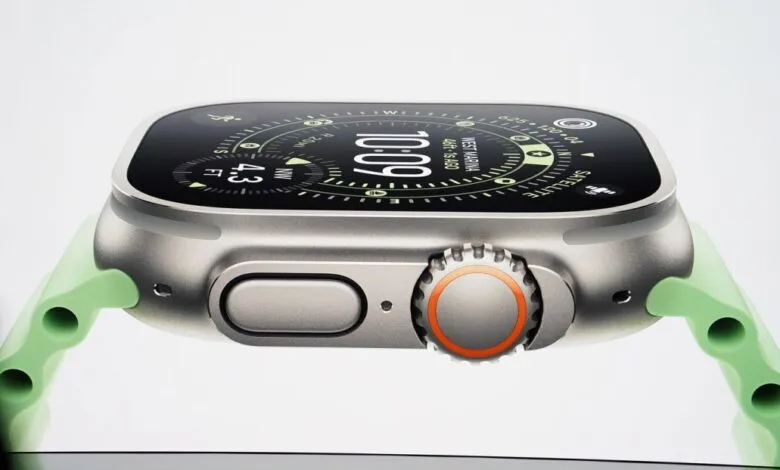 Close-up of Apple Watch Ultra with a light green band, showcasing its digital compass and other features.